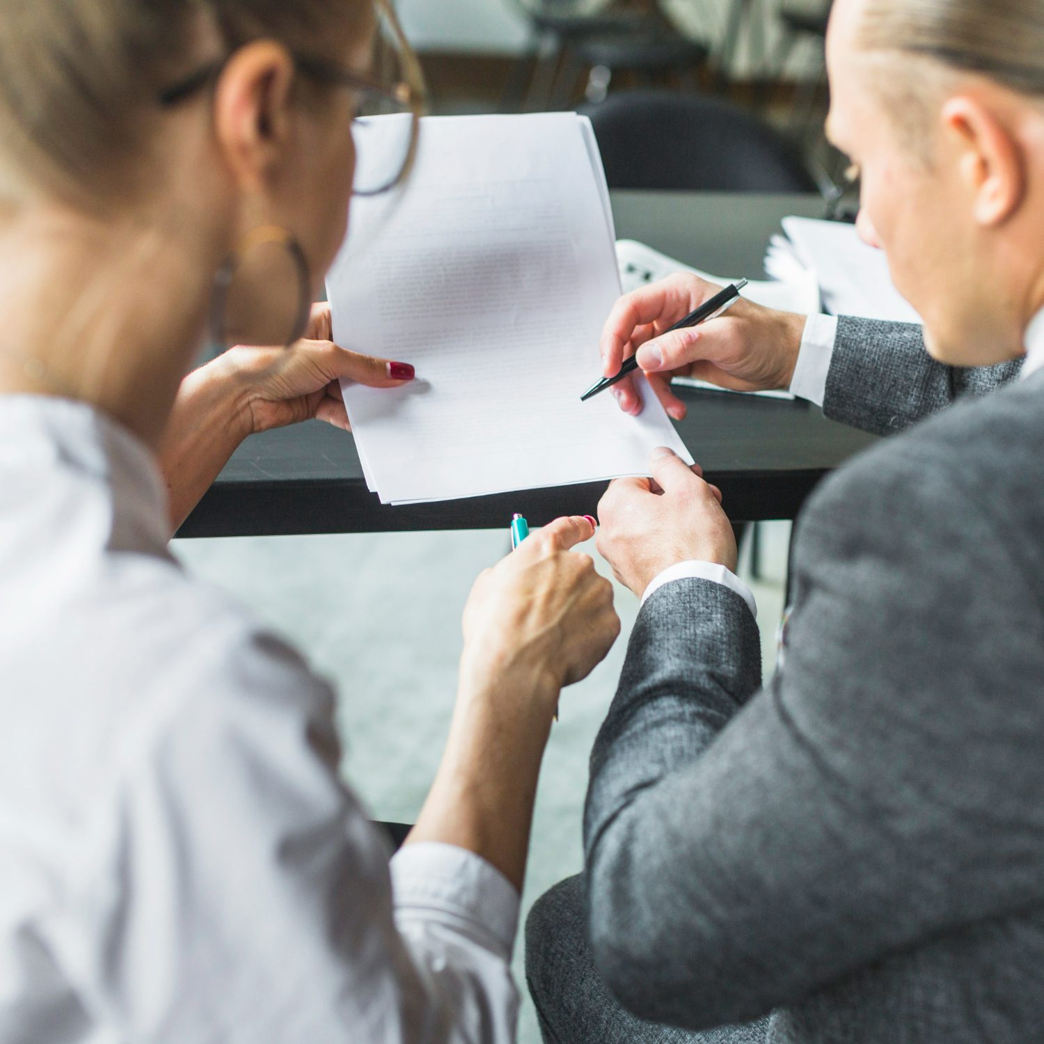 close-up-two-businesspeople-checking-document-restaurant close-up-two-businesspeople-checking-document-restaurant