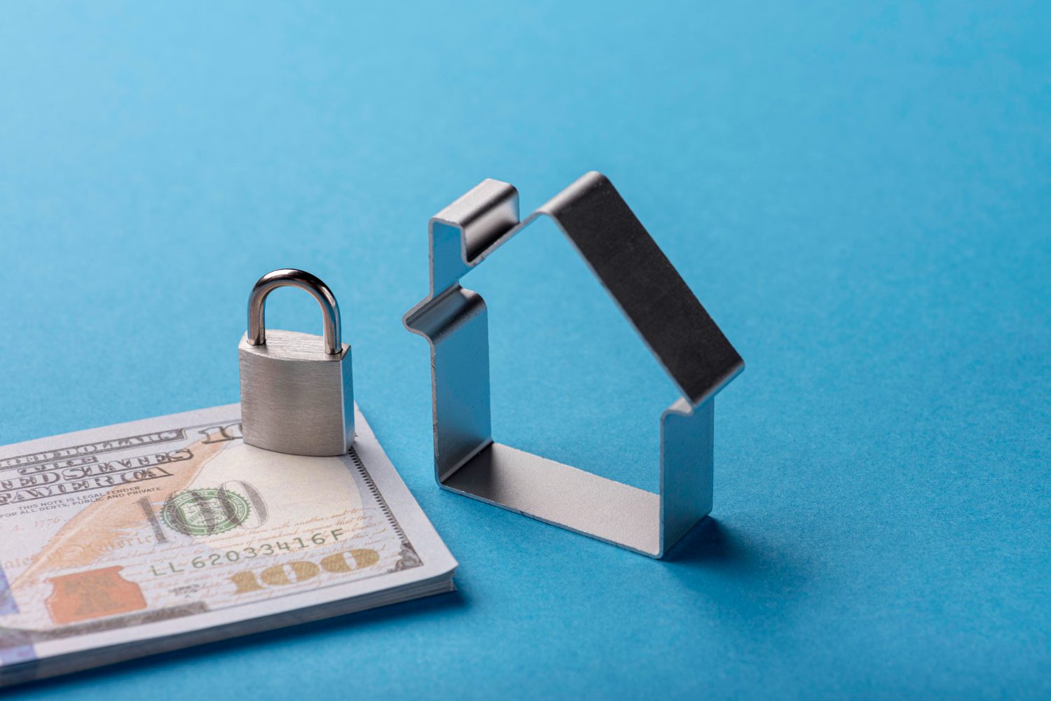 high-angle-banknotes-with-lock-house people sitting at desk working